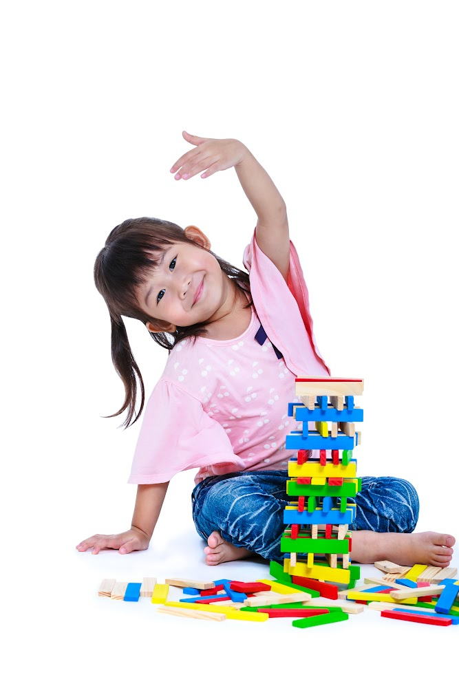 Little Asian girl playing with colored blocks Little Asian girl playing with colored blocks