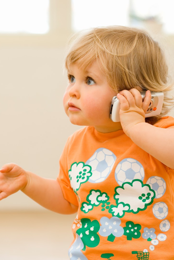 Small child pretending to be on a phone Small child pretending to be on a phone